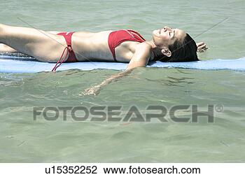 Stock Photo - view of a woman 
lying on a surfboard. 
fotosearch - search 
stock photos, 
pictures, images, 
and photo clipart