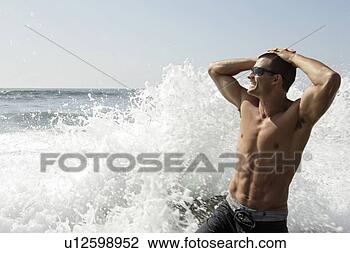 Stock Photo - view of a young 
man enjoying the 
waves. fotosearch 
- search stock 
photos, pictures, 
images, and photo 
clipart