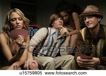 Stock Image - four young people 
playing cards. 
fotosearch - search 
stock photos, 
pictures, images, 
and photo clipart