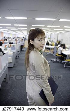 Stock Photograph - a woman turning 
back and looking 
at the camera 
in the office. 
fotosearch - search 
stock photos, 
pictures, images, 
and photo clipart
