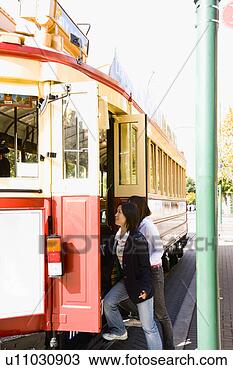 Stock Photo - two young women 
getting on a tram. 
fotosearch - search 
stock photos, 
pictures, images, 
and photo clipart