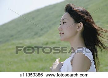 Banco de Imagem - jovem,  mulher, 
 ficar,  campo. 
fotosearch - busca 
de fotos, imagens 
e clipart