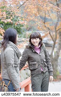 Picture - two young women 
standing on bridge 
at ohara sanzenin 
temple,  kyoto. 
fotosearch - search 
stock photos, 
pictures, images, 
and photo clipart