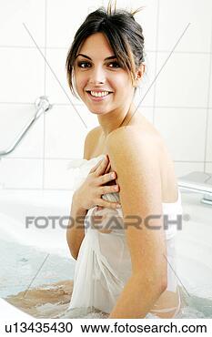 Stock Photography - young naked woman 
sitting in bathtub, 
 translucent cloth 
wrapped. fotosearch 
- search stock 
photos, pictures, 
images, and photo 
clipart