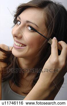 Stock Photo - young woman applying 
make-up. fotosearch 
- search stock 
photos, pictures, 
images, and photo 
clipart