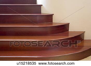 Stock Image - detail of curved 
wooden steps against 
wall. fotosearch 
- search stock 
photos, pictures, 
images, and photo 
clipart