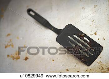 Stock Photograph - detail of a dirty 
spatula on a dirty 
baking sheet. 
fotosearch - search 
stock photos, 
pictures, images, 
and photo clipart