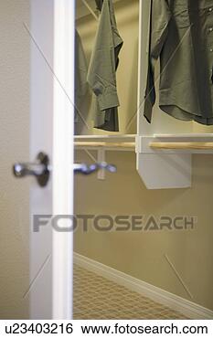 Stock Photo - view past cloaset 
door in to a closet. 
fotosearch - search 
stock photos, 
pictures, images, 
and photo clipart