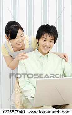 Stock Photography - couple looking 
at pc. fotosearch 
- search stock 
photos, pictures, 
images, and photo 
clipart