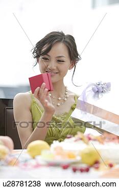 Stock Photo - young woman holding 
a red gift box. 
fotosearch - search 
stock photos, 
pictures, images, 
and photo clipart