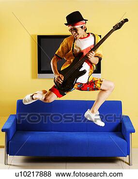 Stock Photo - fashionable young 
man jumping and 
playing guitar. 
fotosearch - search 
stock photos, 
pictures, images, 
and photo clipart
