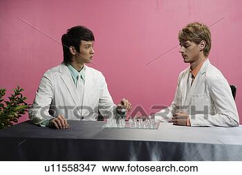 Picture - occidental man 
and asian man 
playing chess 
at desk. fotosearch 
- search stock 
photos, pictures, 
images, and photo 
clipart