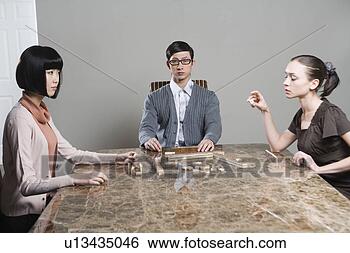 Stock Photo - young man and 
two young woman 
playing with mah-jong. 
fotosearch - search 
stock photos, 
pictures, images, 
and photo clipart