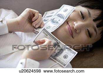 Stock Photo - young woman with 
dollar. fotosearch 
- search stock 
photos, pictures, 
images, and photo 
clipart