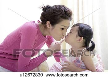 Stock Photography - daughter kissing 
mother. fotosearch 
- search stock 
photos, pictures, 
images, and photo 
clipart