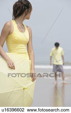 Stock Photo - young woman holding 
an umbrella in 
front of young 
man. fotosearch 
- search stock 
photos, pictures, 
images, and photo 
clipart