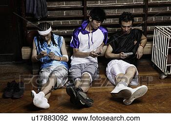 Stock Photo - three basketball 
players sitting, 
playing with cellphones. 
fotosearch - search 
stock photos, 
pictures, images, 
and photo clipart