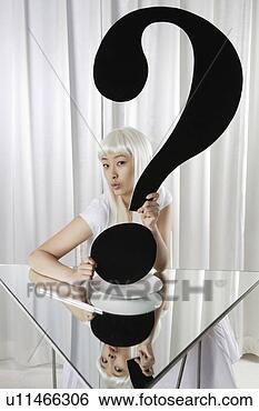 Stock Photo - fashionable young 
woman holding 
a sign of question 
mark. fotosearch 
- search stock 
photos, pictures, 
images, and photo 
clipart