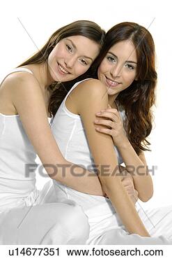 Stock Photography - portrait of a 
young woman hugging 
another young 
woman. fotosearch 
- search stock 
photos, pictures, 
images, and photo 
clipart
