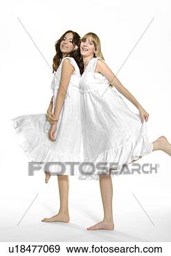 Stock Photograph - portrait of two 
young women standing 
on their one leg 
and smiling. fotosearch 
- search stock 
photos, pictures, 
images, and photo 
clipart