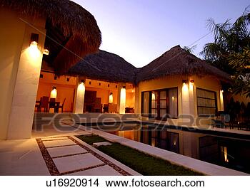 Stock Photo - swimming pool 
and a house lit 
up at night. fotosearch 
- search stock 
photos, pictures, 
images, and photo 
clipart