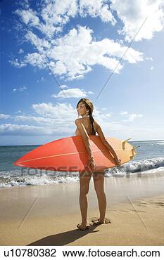 Stock Photo - young pretty caucasian 
 woman in bikini 
standing with 
surfboard at. 
fotosearch - search 
stock photos, 
pictures, images, 
and photo clipart