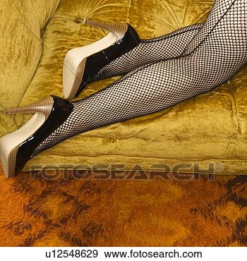 Stock Photograph - pretty caucasian 
woman in lingerie 
and fishnet stockings 
on sofa. fotosearch 
- search stock 
photos, pictures, 
images, and photo 
clipart