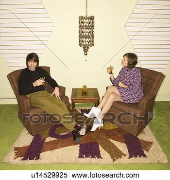 Stock Image - caucasian mid-adult 
man and woman 
wearing vintage 
clothing seated 
in. fotosearch 
- search stock 
photos, pictures, 
images, and photo 
clipart