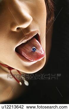 Stock Photo - close up portrait 
of young caucasian 
woman sticking 
out pierced tongue. 
fotosearch - search 
stock photos, 
pictures, images, 
and photo clipart
