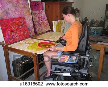 Stock Photo - artist (female 
wheelchair user) 
puts paint and 
brush to canvas 
in her. fotosearch 
- search stock 
photos, pictures, 
images, and photo 
clipart