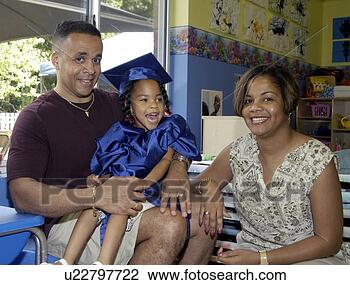 Stock Photo - proud and happy 
family on the 
day of their daughteræs 
pre-school. fotosearch 
- search stock 
photos, pictures, 
images, and photo 
clipart
