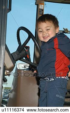 Stock Photo - cute little boy 
with disabilities 
in the cab of 
a tractor. fotosearch 
- search stock 
photos, pictures, 
images, and photo 
clipart