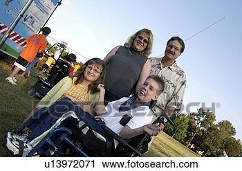 Stock Photography - diagonal view 
of a boy with 
a disability and 
his family having 
a good. fotosearch 
- search stock 
photos, pictures, 
images, and photo 
clipart