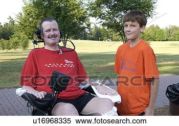 Stock Image - man with a disability 
and his son spending 
time together 
in the park. fotosearch 
- search stock 
photos, pictures, 
images, and photo 
clipart