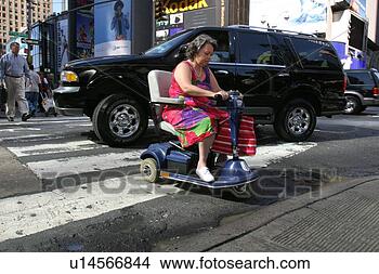 Stock Photo - woman crossing 
a busy city street 
using a scooter. 
fotosearch - search 
stock photos, 
pictures, images, 
and photo clipart