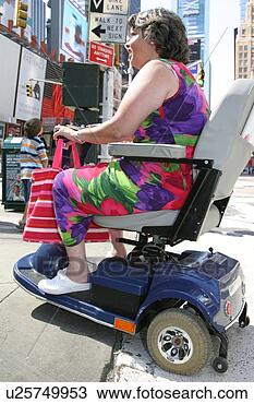 Stock Photo - woman crossing 
a city street 
using scooter/cart. 
fotosearch - search 
stock photos, 
pictures, images, 
and photo clipart