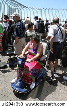 Stock Photo - woman in scooter/cart 
enjoying the sights 
of new york city. 
fotosearch - search 
stock photos, 
pictures, images, 
and photo clipart