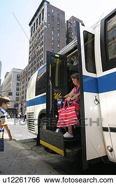 Stock Photo - woman using a 
scooter/cart for 
mobility leaving 
a city bus via 
a lift. fotosearch 
- search stock 
photos, pictures, 
images, and photo 
clipart