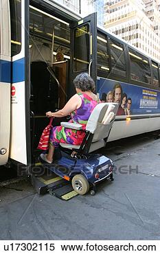 Stock Image - woman using a 
scooter/cart for 
mobility getting 
on a city bus 
via a. fotosearch 
- search stock 
photos, pictures, 
images, and photo 
clipart
