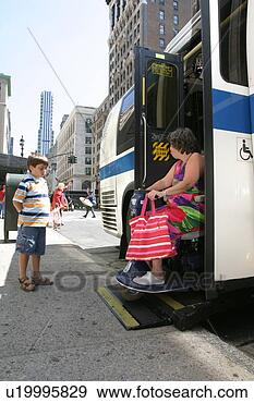 Stock Photograph - woman using a 
scooter/cart for 
mobility leaving 
a city bus via 
a lift. fotosearch 
- search stock 
photos, pictures, 
images, and photo 
clipart