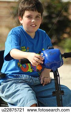 Stock Photography - boy with muscular 
dystrophy utilizing 
a scooter/cart 
for mobility. 
fotosearch - search 
stock photos, 
pictures, images, 
and photo clipart