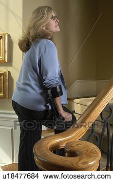 Stock Photo - lady with arm 
crutches walks 
upstairs. fotosearch 
- search stock 
photos, pictures, 
images, and photo 
clipart