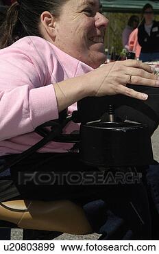 Stock Photograph - side shot of woman 
using a power 
wheelchair. fotosearch 
- search stock 
photos, pictures, 
images, and photo 
clipart