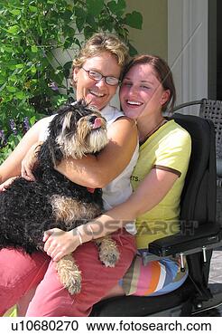 Stock Photography - mother and pet 
dog share a ride 
with daughter 
using an electric. 
fotosearch - search 
stock photos, 
pictures, images, 
and photo clipart