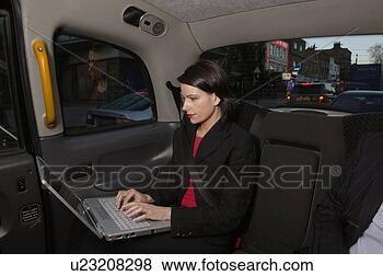 Stock Photo - business woman 
with laptop in 
taxi. fotosearch 
- search stock 
photos, pictures, 
wall murals, images, 
and photo clipart
