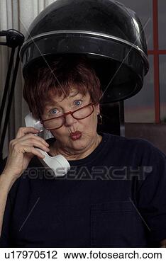 Stock Photo - woman on phone 
in old-fashioned 
hair dryer. fotosearch 
- search stock 
photos, pictures, 
images, and photo 
clipart