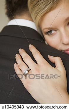 Stock Photo - a bride hugs her 
husband. fotosearch 
- search stock 
photos, pictures, 
wall murals, images, 
and photo clipart