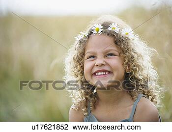 Stock Photo - young girl laughing 
with daisies in 
hair. fotosearch 
- search stock 
photos, pictures, 
images, and photo 
clipart