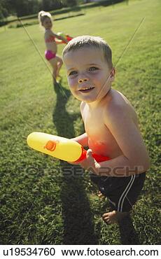 Stock Photography - children playing 
in the park with 
water pistols. 
fotosearch - search 
stock photos, 
pictures, images, 
and photo clipart