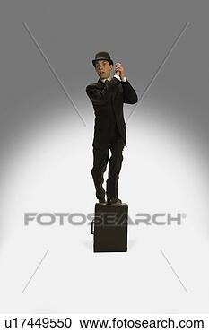 Stock Photography - a winning businessman 
stands on his 
briefcase. fotosearch 
- search stock 
photos, pictures, 
images, and photo 
clipart